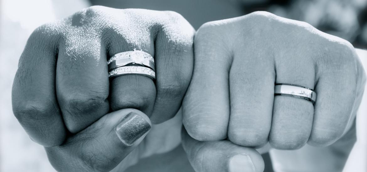 Couple showing their wedding rings.